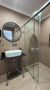 a bathroom with a sink and a mirror at Vila Klea in Ksamil