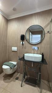 a bathroom with a sink and a mirror at Vila Klea in Ksamil +17 photos