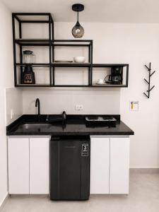 a kitchen with a sink and a counter top at Qantic Lodging & Rooftop in Medellín