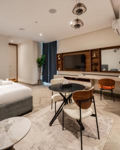 a hotel room with a bed and a table and chairs at Zee Residence in Lagos