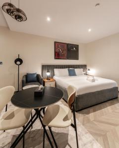 a bedroom with a bed and a table and chairs at Zee Residence in Lagos