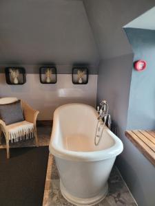 a bathroom with a white tub in a room at BELLFIELD HOUSE in Broadford +125 photos