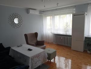 a living room with a chair and a table at Strzelce in Strzelce Krajeńskie