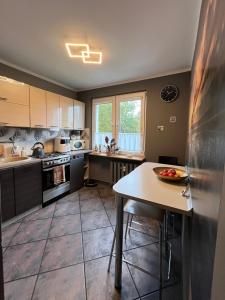 a kitchen with a table and a counter top at Strzelce in Strzelce Krajeńskie