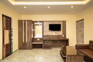 a living room with a television and a couch at Mahabhoj Hotel & Restaurant in Mandarmoni