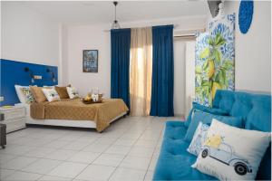 a bedroom with a bed and a blue couch at vranas hotel in Skala Sotiros