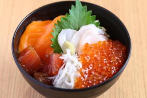 a black bowl of food with meat and sauce at Onyado Nono Kanazawa in Kanazawa