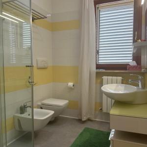a bathroom with a toilet and a sink and a shower at Mare e Tulipani in Porto San Giorgio