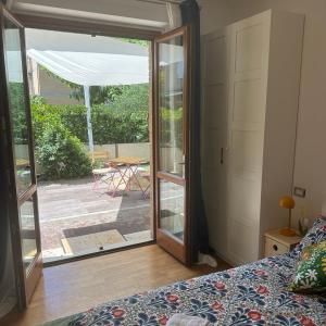 a bedroom with a door open to a patio at Mare e Tulipani in Porto San Giorgio