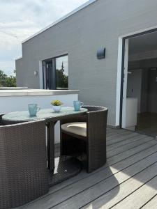 a patio with a table and chairs on a deck at SOFI-LIVING-APARTMENTS in Hannover