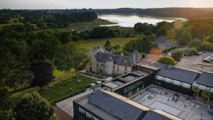an aerial view of a large castle with a river at La Maison OBONO Hôtel Restaurant & Spa in Le Bono