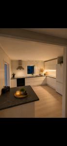 a kitchen with a table and a counter top at Modern Ocean Escape, Lofoten in Sund