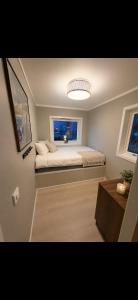 a small bedroom with a bed and a window at Modern Ocean Escape, Lofoten in Sund