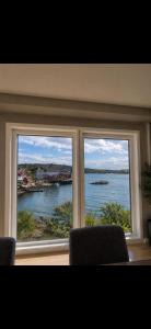 a window with two chairs and a view of the water at Modern Ocean Escape, Lofoten in Sund