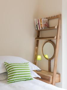 a bedroom with a mirror and a bed at North Parade Avenue in Oxford