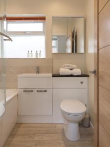 a bathroom with a toilet and a sink and a mirror at North Parade Avenue in Oxford