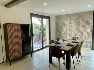 a dining room with a wooden table and chairs at Le Balcon de Narlay in Le Frasnois +42 photos