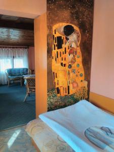 a bedroom with a painting on the wall next to a bed at Bonbon Guest House in Panagyurishte