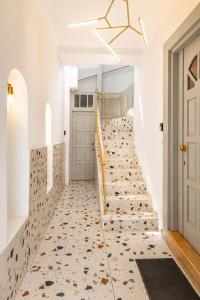 a staircase with a tile floor and a door at Apeiron Acropolis Suites by HC in Athens