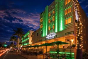 a hotel with green lights on a street at night at Beacon South Beach Hotel in Miami Beach