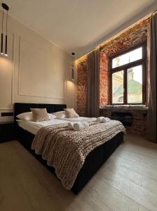 a bedroom with a large bed and a window at GRATIA RESIDENCE Lublin in Lublin