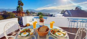 two plates of food on a table on a balcony at דאוס האוס - דירות אירוח מודרניות ושקטות in Eilat
