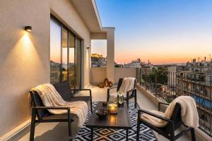 a balcony with a table and chairs and a view at Corto Maltese Boutique in Athens
