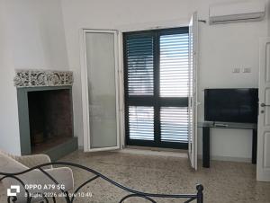 a living room with a fireplace and a television at Borghetto sant'irene in Erchie