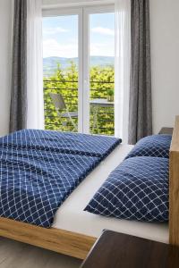 a bedroom with two beds and a window at Apartman Promaja in Široki Brijeg
