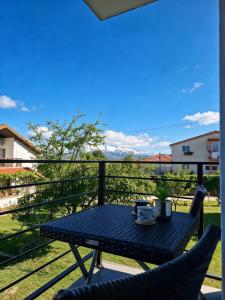 a table and two chairs on a balcony at Apartman Promaja in Široki Brijeg