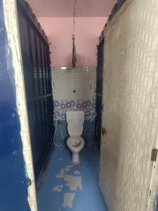 a bathroom with a toilet in a room at Terrace Camp inn in Tiruchirappalli +110 photos