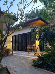 a house with a table and benches in front of it at Jepara Garden Resort in Jepara