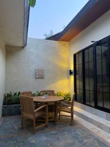 a wooden table and chairs on a patio at Jepara Garden Resort in Jepara
