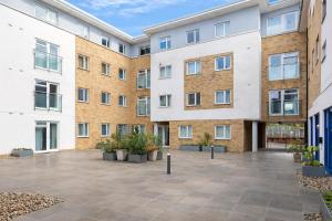 an empty courtyard in front of an apartment building at Roomspace Serviced Apartments - Abbot's Yard in Guildford