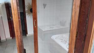 a glass door of a bathroom with a sink at Ocean view boutique in Nungwi +14 photos