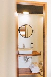 a bathroom with a sink and a mirror at Casa Luz Paraty in Paraty +84 photos