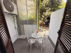 a small patio with a table and chairs on a balcony at Boutique Hotel Washington Milano - JCUBE HOTELLERIE in Milan