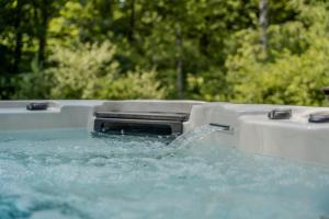 a water gun on top of a pool of water at Luxury Lodge with Private Jacuzzi for 4 – Woodz Lodges Heusden-Zolder in Heusden - Zolder