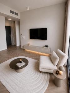 a living room with a flat screen tv on the wall at Nad Zatoką Apartament 340 in Olsztyn