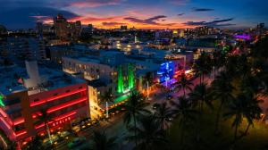 a city lit up at night with colorful lights at Beacon South Beach Hotel in Miami Beach