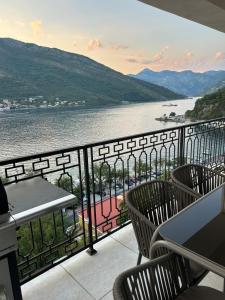 a balcony with chairs and a view of a river at L 32 Sea view in Lepetani