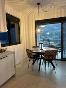 a kitchen and dining room with a table and chairs at L 32 Sea view in Lepetani
