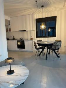 a kitchen and dining room with a table and chairs at L 32 Sea view in Lepetani +16 photos