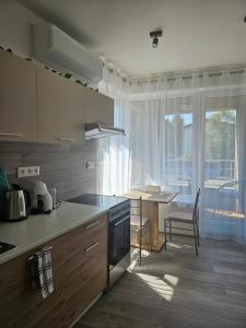 a kitchen with a table and a dining room at Apartmány Koliba in Turčianske Teplice