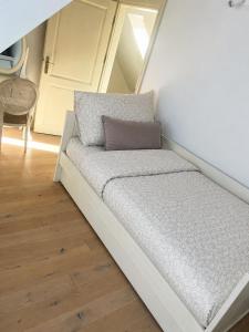 a small bed in a small room with at Willa Oliwa in Gdańsk