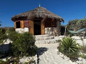 a small hut with a straw roof on a beach at Manga Bay Lodge in Toliara