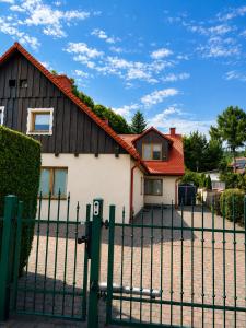a house with a gate in front of it at Willa Oliwa in Gdańsk