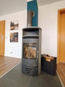 a wood stove in a room with at Apartment Selina in Lichtenhain