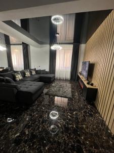 a living room with a couch and a television at IUNIk in Azuga