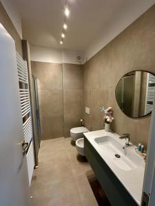 a bathroom with a toilet and a sink and a mirror at Casa Rita in Fano